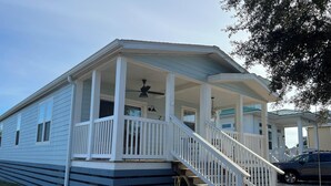 A mobile home with a porch, a staircase, and a visible number '178'. - Pet Friendly Beach House - Hakuna Matata (Port St. Joe)
