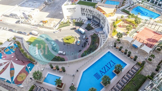 An aerial view of a hotel complex with multiple swimming pools, a central courtyard, and a large building labeled "Fawad Aziza." - Bloomfields Cozy STU Azizi Farhad (Dubai)