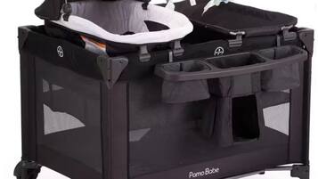 A black travel stroller with a canopy, storage basket, and a baby seat.