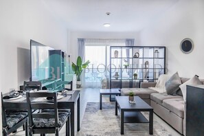 En moderne stue med sofa, sofabord og spiseplads.