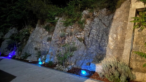 A rocky outdoor area with a water feature and plants. - Enjoy KRK waterfalls, sun, beach and sea: Domicile Sunce Krka Studio (Skradin)