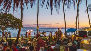 An outdoor dining area with tables and chairs, overlooking the ocean. - Waikiki Marina Ocean View Studio w/ Parking (Honolulu)