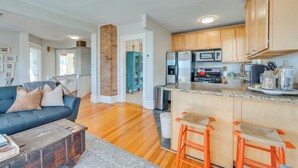 A modern kitchen with wooden cabinets, a stainless steel refrigerator, and a built-in microwave. - 1 Mi to CU Boulder: Condo Near Pearl Street! (Boulder)
