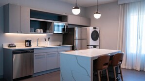 A modern kitchen with stainless steel appliances, a central island, and pendant lighting. - Homewood Suites By Hilton Hoover Birmingham (Birmingham)