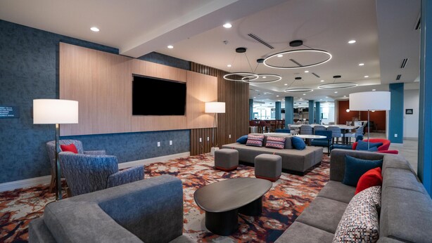 A modern lounge area with sofas, armchairs, and a coffee table. - Homewood Suites By Hilton Hoover Birmingham (Birmingham)