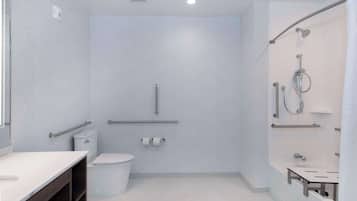 A modern bathroom with a shower, toilet, and sink.