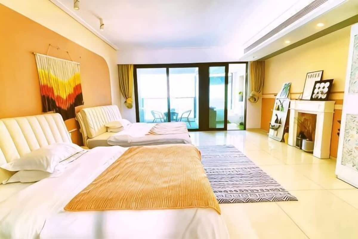 Ein Hotelzimmer mit einem großen Bett, zwei Sesseln, einem Sofa, einem Kamin und einem Balkon mit Aussicht.