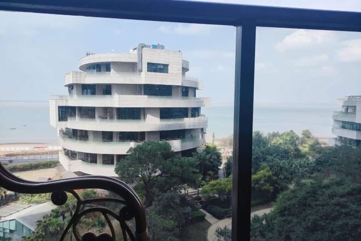 Ein mehrstöckiges Gebäude mit kreisförmigem Design, großen Fenstern und Blick aufs Meer.