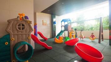 A children's play area with slides and swings.