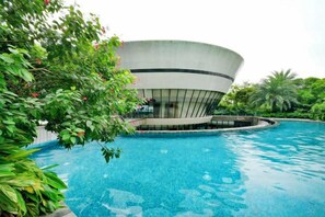 A swimming pool with a modern building in the background.