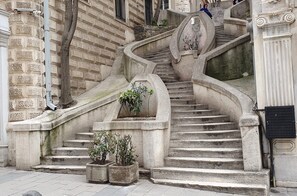 A set of stone stairs with a curved design, leading up to a building entrance. - Les Temps Istanbul Karakoy, Curio Collection By Hilton (Istanbul)
