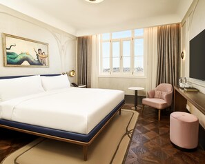 A hotel room with a large bed, a desk with a chair, a small table, and a large window with curtains. - Les Temps Istanbul Karakoy, Curio Collection By Hilton (Istanbul)
