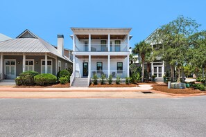A two-story house with a balcony, a covered porch, and a driveway. - Mimi's Pearl (Santa Rosa Beach)