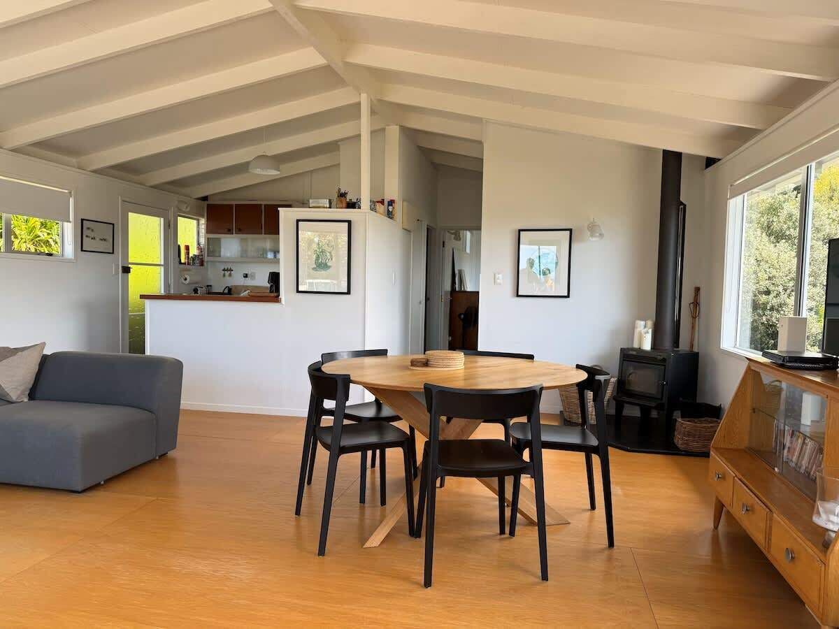 A modern interior with a dining area, kitchen, and living space.