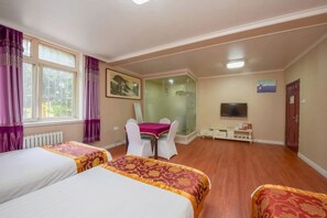 A hotel room with two beds, a desk with a chair, a television, and a shower area. - Shijiazhuang Junting Express Hotel (Shijiazhuang)