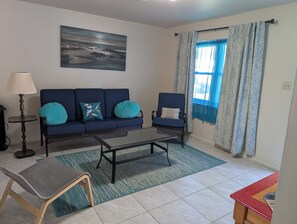 A living room with a sofa, two armchairs, a coffee table, a lamp, and a painting on the wall. -  3-bedroom Make yourself home while in  Rockdale B (Rockdale)
