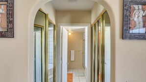 A hallway with mirrored doors, a white towel hanging, and a small rug on the floor. - Best Pet Friendly Home In Bullhead City (Bullhead City)