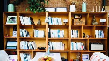 A room with a large wooden bookshelf filled with books and decorative items.