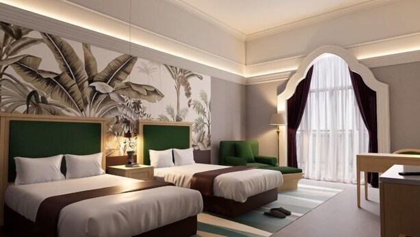 A hotel room with two beds, a large tropical mural, a green accent wall, a desk, and a window with curtains. - Sun City Huiyue Hotel (Daying)