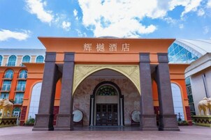 The entrance of the hotel with a large archway and two elephant statues on either side.