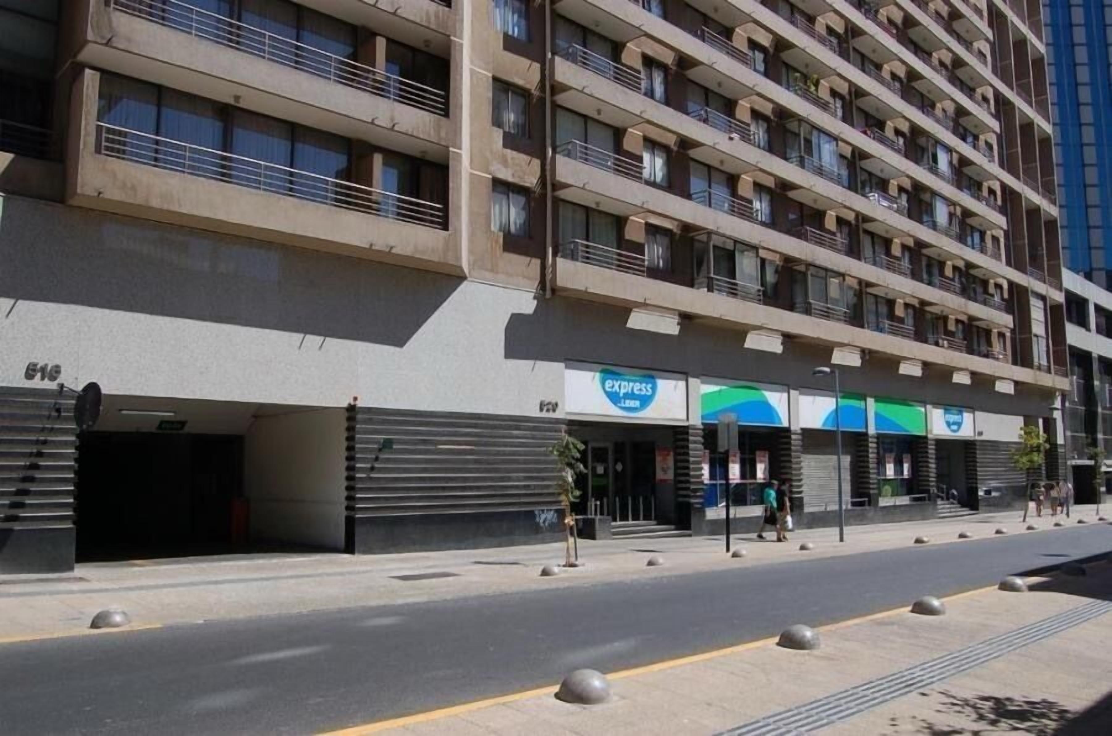 A multi-story hotel with a modern design, featuring balconies on each floor.