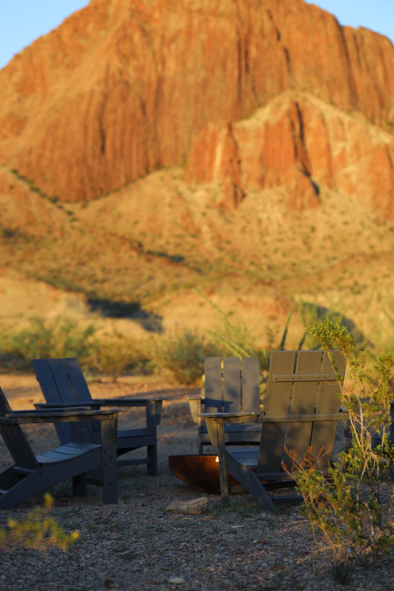 Outdoor seating with a view of a large rock formation.