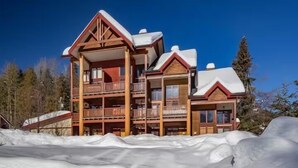 A multi-story lodge with balconies, wooden exterior, and snow-covered roofs. - Red Mtn views, walk to lift, 2 bed, 2 bath condo. Fireplace! (Trail)