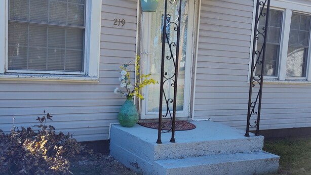 A single-story house with a front porch, a mailbox, and a number '275' on the door.