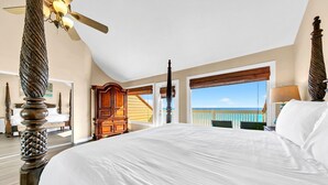 A spacious bedroom with a large bed, a wooden wardrobe, and a view of the ocean. - Free Beach Service~ Beachfront Townhome ~ Sleeps 8-GreenReef #4 (Destin)