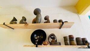 Two wooden shelves with various pottery items. - San Cristóbal Bleisure Hotel (San Cristóbal de las Casas)