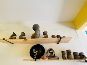 Two wooden shelves with various pottery items. - San Cristóbal Bleisure Hotel (San Cristóbal de las Casas)