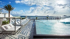 A rooftop pool with lounge chairs and a view of the ocean. - ⚓️LUXURY BEACHFRONT CONDO⚓️
 W Hotel Residences- In House Arcade in Condo⚓️ (Fort Lauderdale)