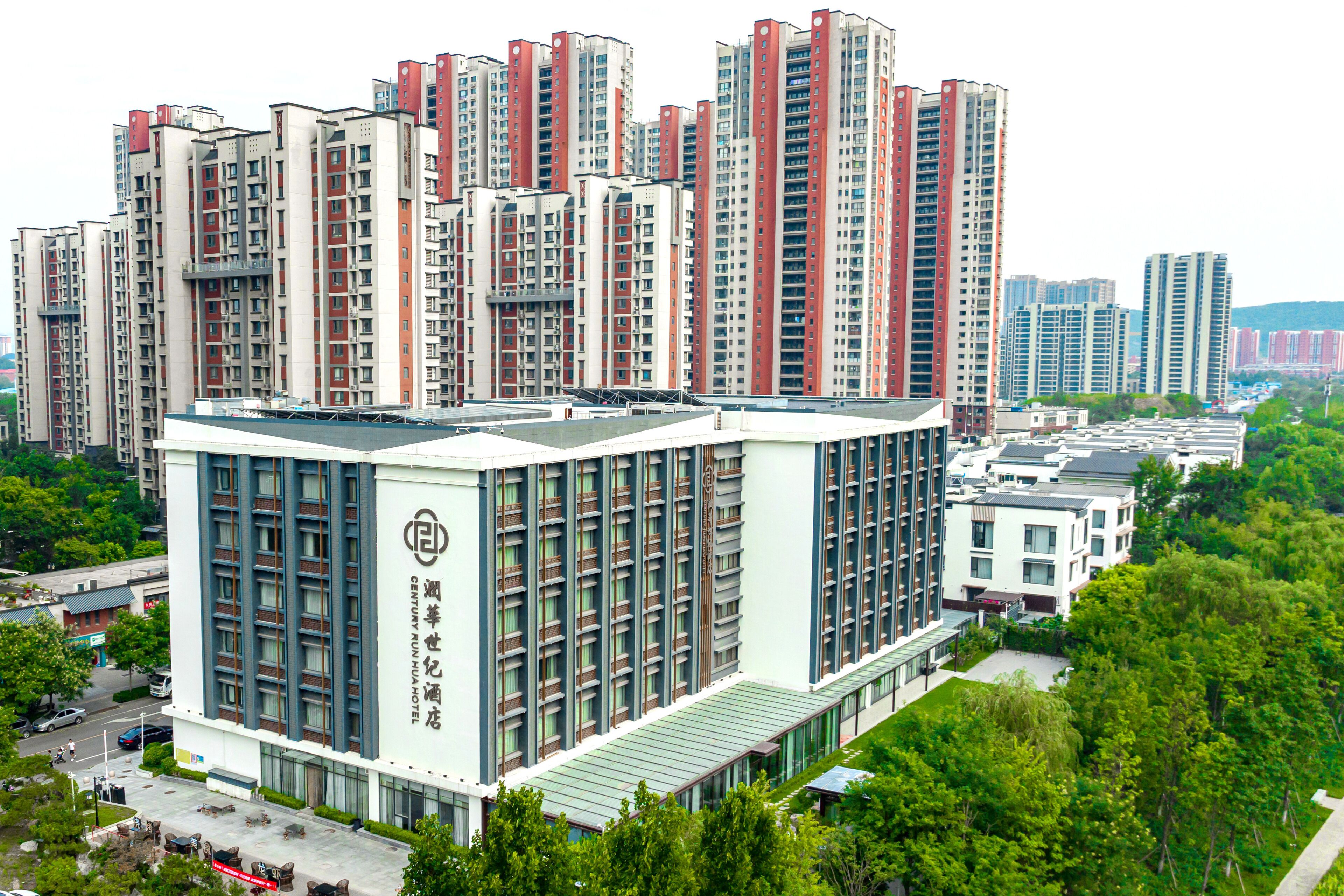 A high-rise hotel with multiple floors, large windows, and a prominent entrance.
