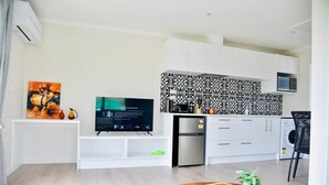 A modern kitchen with white cabinets, a stainless steel refrigerator, and a microwave. - Stellar A- Sweet unit in Lake Tekapo (Lake Tekpao)