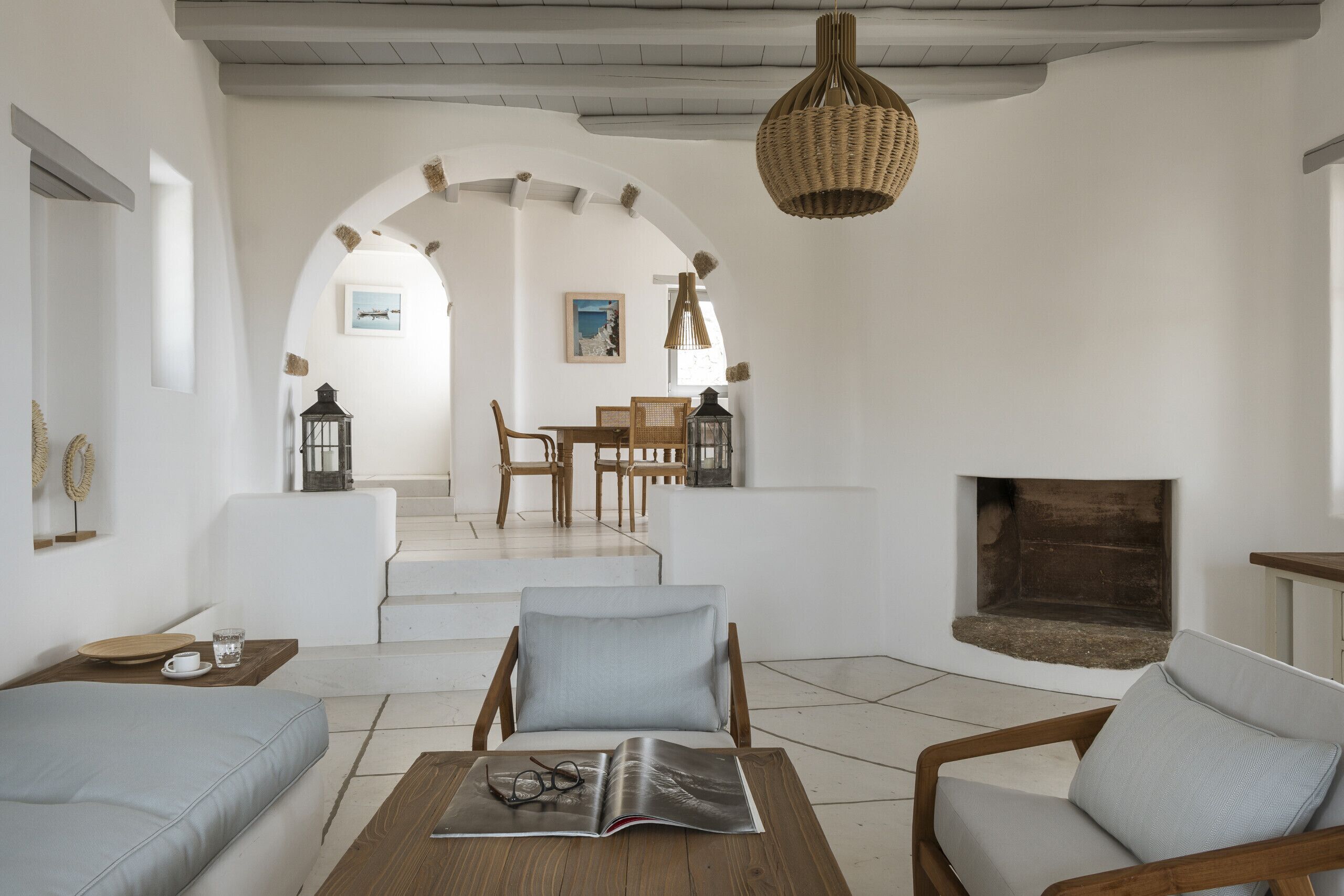 A spacious living room with a fireplace, a dining area, and a cozy seating arrangement.