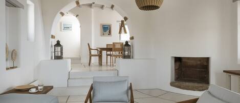 A spacious living room with a fireplace, a dining area, and a cozy seating arrangement.