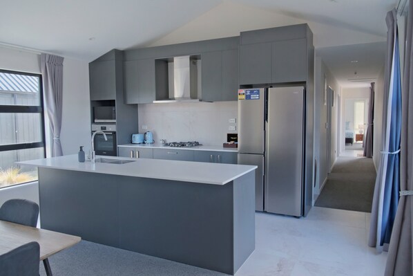 Enjoy cooking in this well-equipped kitchen with a central island and appliances.