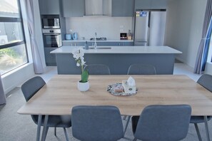 Enjoy cooking in this well-lit kitchen with a central island, sink, and microwave.