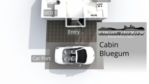 A cabin layout with a lounge, kitchen, bathroom, and entry point.