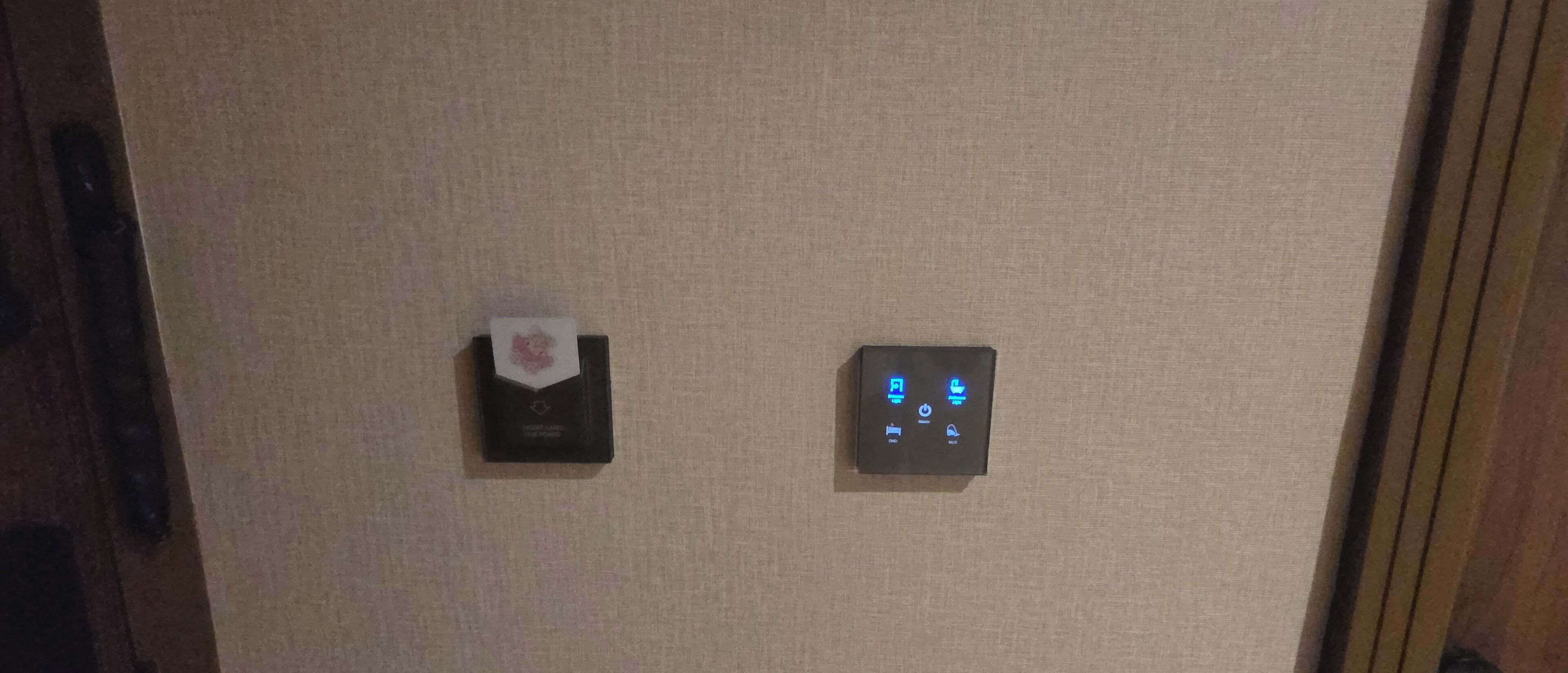 A wall-mounted control panel with a digital display and a card reader.