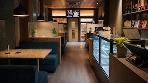 A restaurant interior with booths, a bar area, and a TV screen displaying a chef.