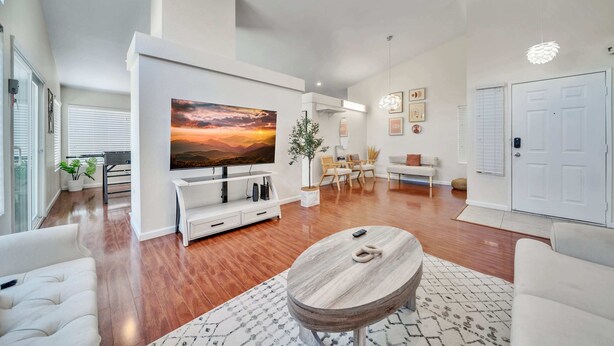 A spacious living room with a large flat-screen TV, a wooden coffee table, and a comfortable seating area. - @marbella Lane - 4BR Lavish Castle Retreat (Indio)