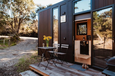 Outdoor dining. Kūaotunu Cabin 1 by Tiny Away