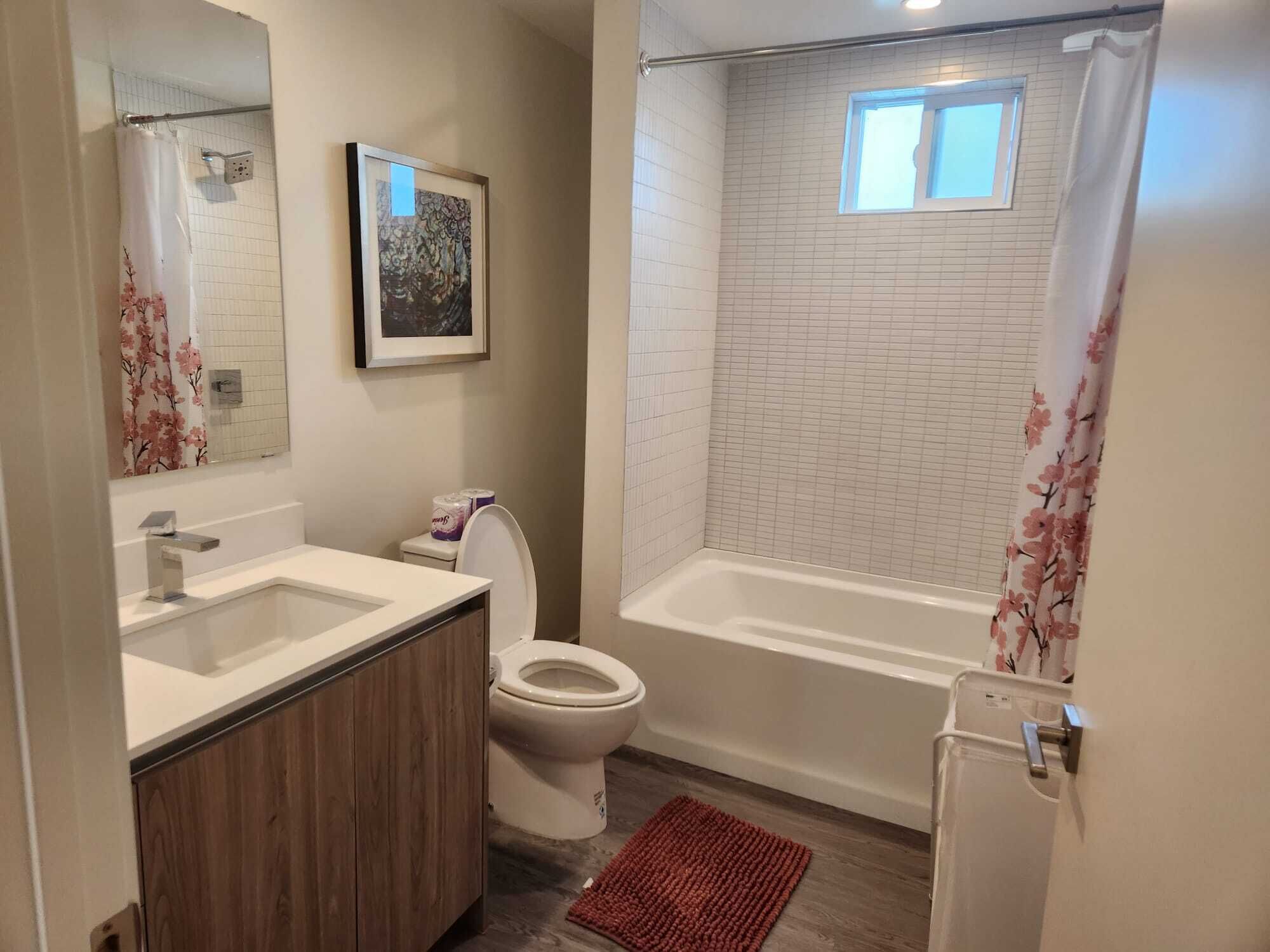 A bathroom with a toilet, sink, and bathtub.