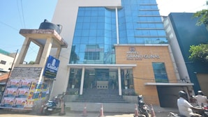 A modern hotel with a glass facade, named 'Hotel Grand Gunas'. - Coastal Grand - COIMBATORE (Coimbatore)