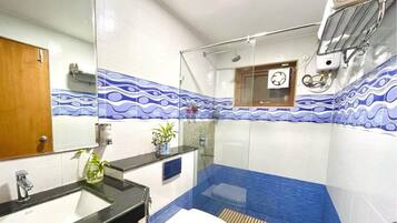 A bathroom with a sink, toilet, and shower area.