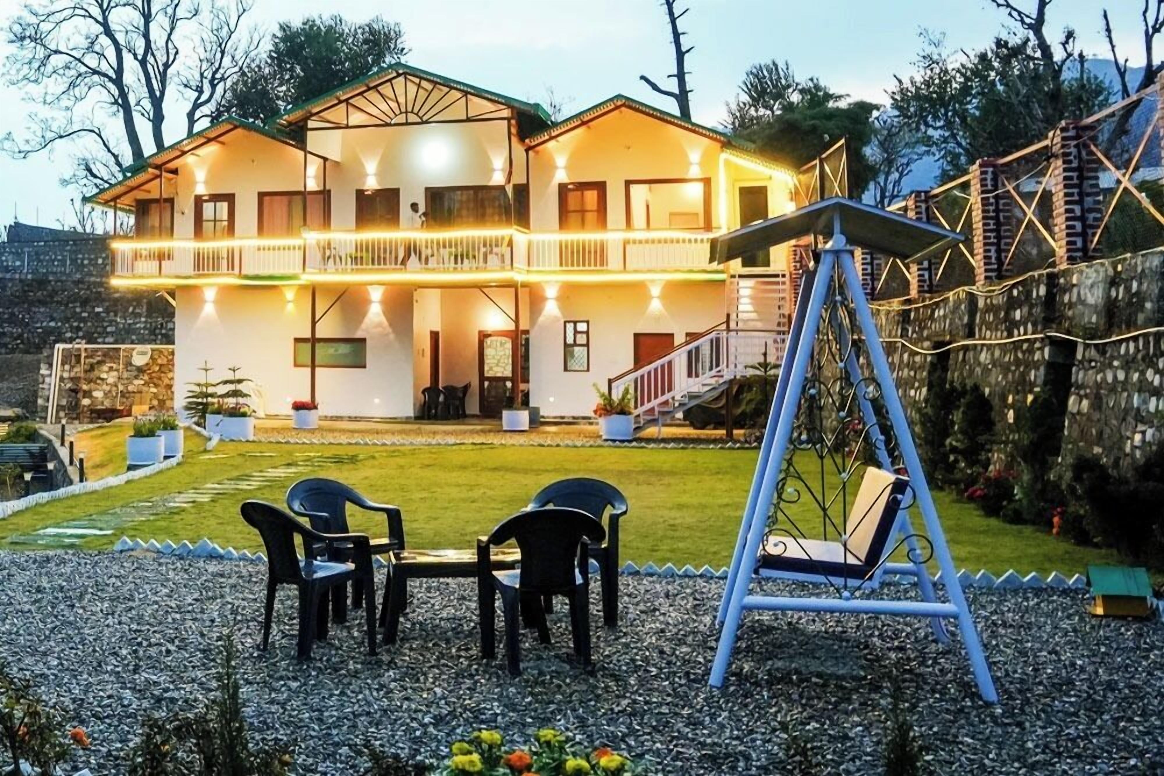 A two-story house with a balcony, a swing, and a solar panel.