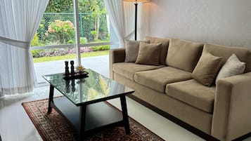 Deluxe Villa, Garden View | Living area | TV