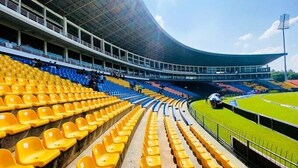 A stadium with tiered seating, a curved roof, and a green field. - Lake Villas Premium Kandy (Kandy)