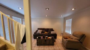 A living room with a sofa, armchair, and coffee table.